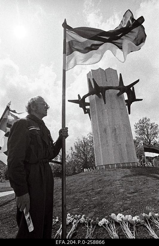 50th anniversary of the June Deportation. Opening of the memorial stone in Rakvere. Dedicated to the oppressed from Virumaa. A man with a flag.
