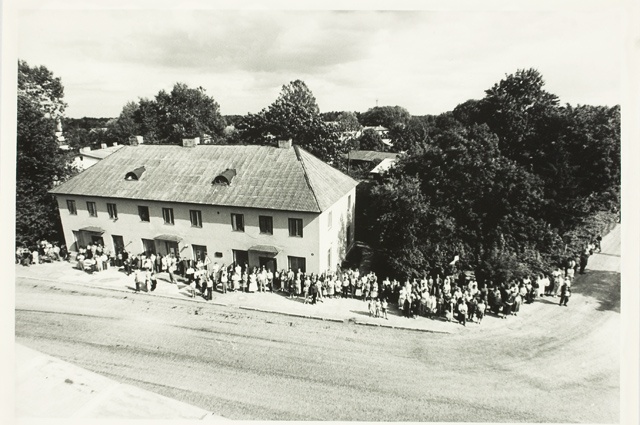 Throwing the Estonian flag on the roof of Rapla United Bank, audience in front of the bank