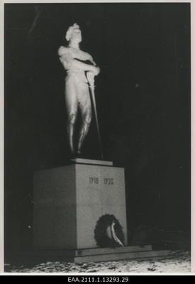 The eve of the 20th anniversary of the Republic of Estonia in Tartu, the choir on the foot of the monument pillar of the War of Independence "Kalevipoeg" illuminated with the projector  similar photo