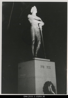 The eve of the 20th anniversary of the Republic of Estonia in Tartu, the choir on the foot of the monument pillar of the War of Independence "Kalevipoeg" illuminated with the projector  similar photo