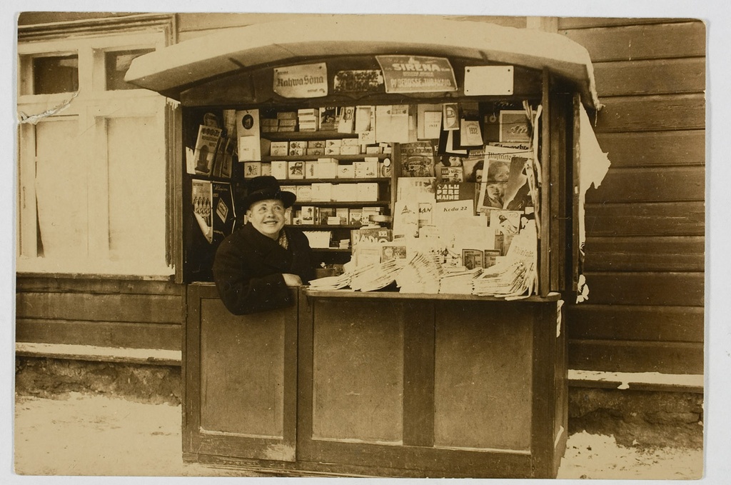 Johannes Lepman oma ajalehekioskis umbes 1930.-1935. aastal. Tallinn, Tartu maantee ja Lastekodu tänava nurgal.