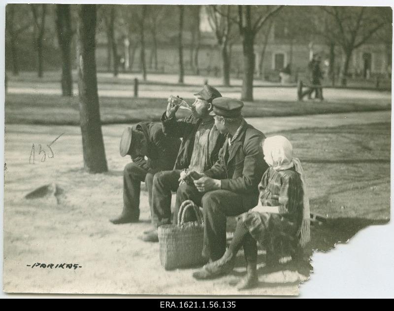 Three men and a little girl sitting on the parking lot