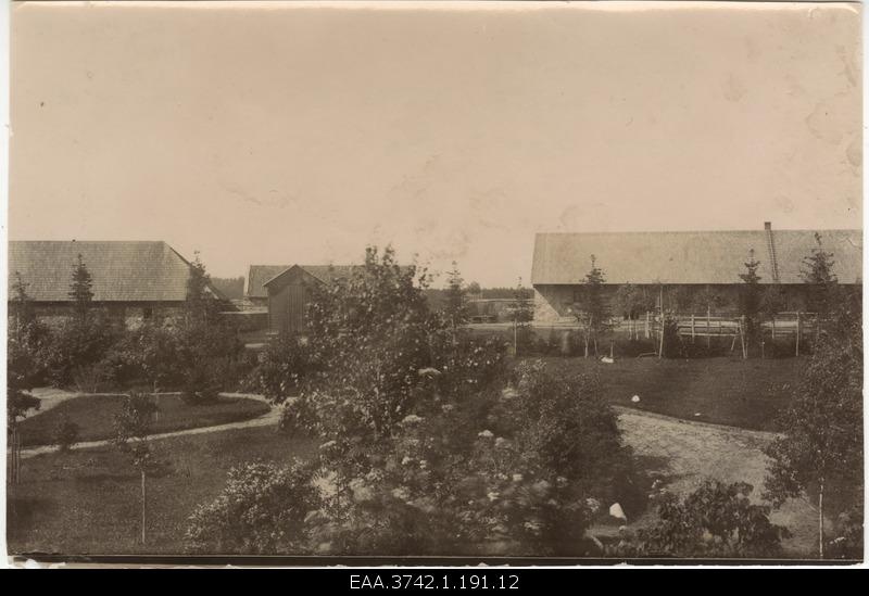 A young beauty garden with pathways. Economic buildings at the same time