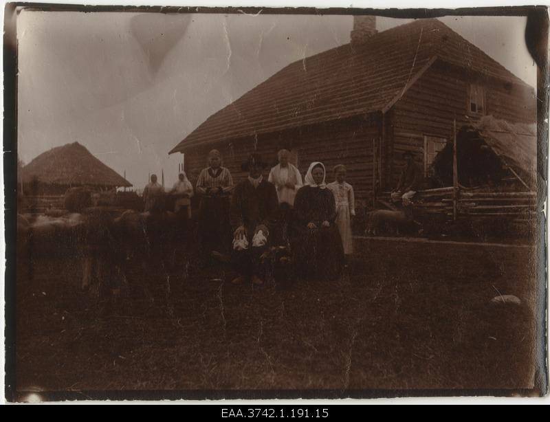 Family posing in front of the farmhouse