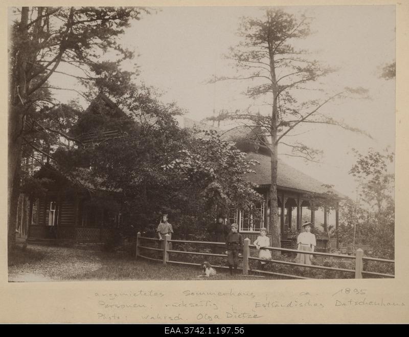 Mrs. Raehlmann with children in front of the summer house