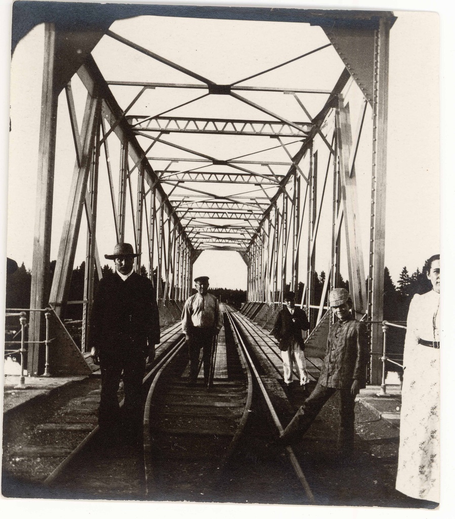 Steel railway bridge near Tartu. People on the railway