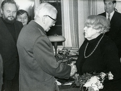 Betti Alver's 75th anniversary evening at the Tartu Writers' House 27th of November 1981. Poetess congratulates Uku Masing, standing behind the left: 1. Tõnis Lehtmets, 2. Irene Leisner, 3. Harald Peep  similar photo