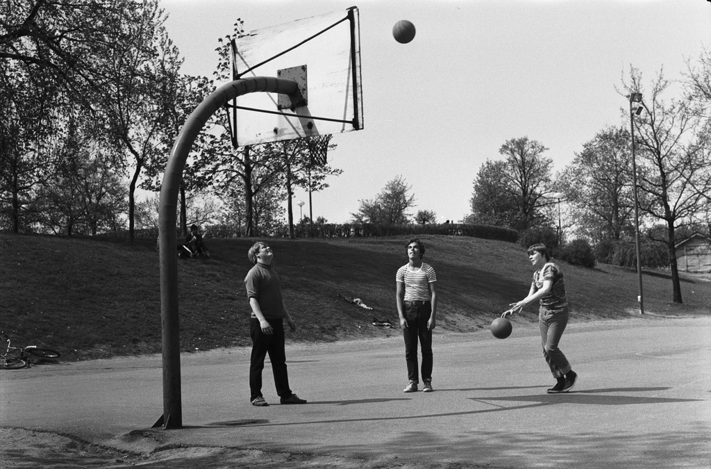Kaisaniemenpuisto. Nuoria miehiä pelaamassa koripalloa Kaisaniemenpuiston luoteiskulmassa.