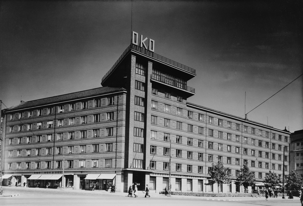 Osuuskassojen Keskusliiton rakennus, Arkadiankatu 23 - Runeberginkatu 23. Rakennuksen ensimmäisen kerroksen liiketiloissa muun muassa Osuuskassojen Keskuslainarahaston konttori, Helsingin Osuuskauppa HOK:n myymälä ja kampaamo.