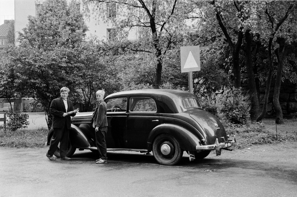 Kaksi poikaa henkilöauton (merkki Mercedes-Benz) luona Agricolankuja 2:n edessä, nykyisen Agricolanpuistikon kohdalla.