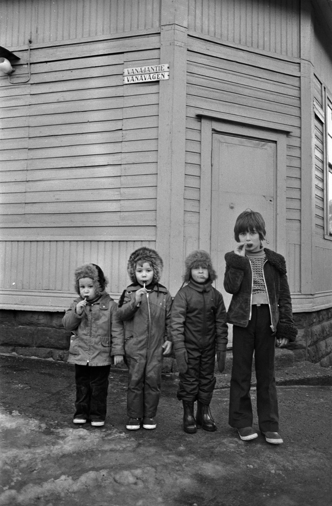 Neljä poikaa syö tikkukaramelleja Vanajantien ja Vallilantien kulmassa Puu-Vallilassa.