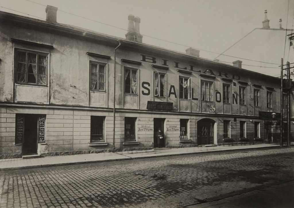Fabianinkatu 14, puurakennuksen julkisivussa on teksti Billard Salon, talon alakerrassa on juomia myyvä liike Aktiebolag Axel Pihlgren.