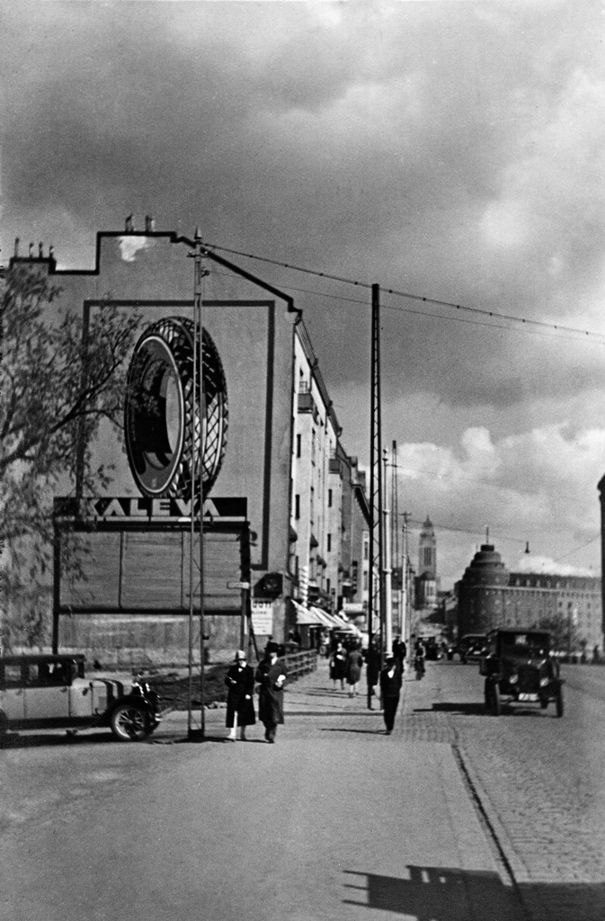 Siltasaarenkatu 2, 4. Pitkänsillan pohjoispäätä.  Taustalla häämöttää Kallion kirkko ja arkkitehti Lars Sonckin piirtämä Arenan talo kolmion muotoisella tontilla, valmistui 1923.