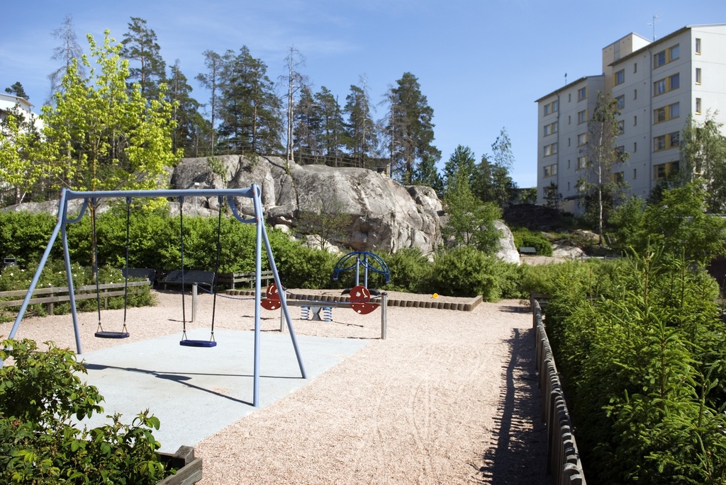 Asukaspuisto Kipinäpuistossa Kivikossa, taustalla Jyrkännekuja 4:n kerrostalo