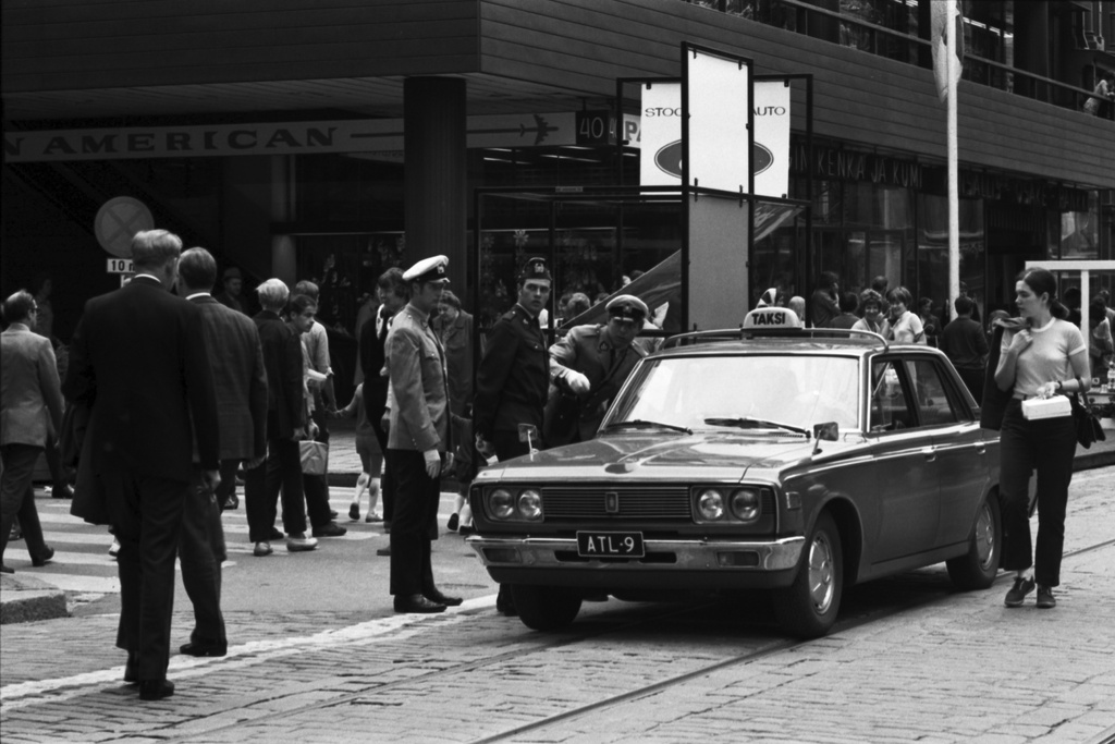 Aleksanterinkatu 40. Poliiseja ohjaamassa taksia Aleksanterinkadulla Kluuvikadun kulmassa kävelykatukokeilun avajaispäivänä.