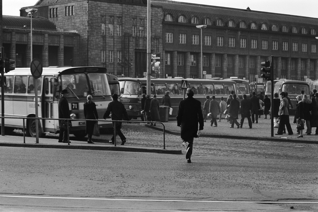 Ihmisiä ja busseja iltapäivän ruuhka-aikaan Rautatientorilla. Näkymä Kaivokadun suunnalta Helsingin rautatieasemalle päin.