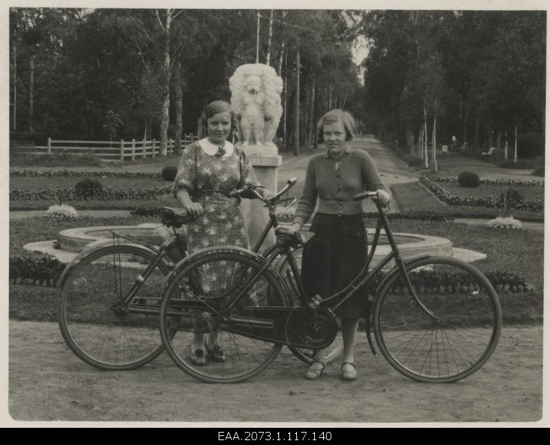 Girls with bikes in the background of Pärnu mudravila in the fountain