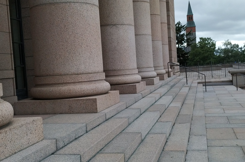 Mannerheimintie 30. Men (People?) On the stairs of the House of Representatives, following a demonstration demanding higher education democracy. rephoto