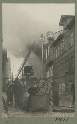 Fire extinguishing in the wooden house district.  similar photo
