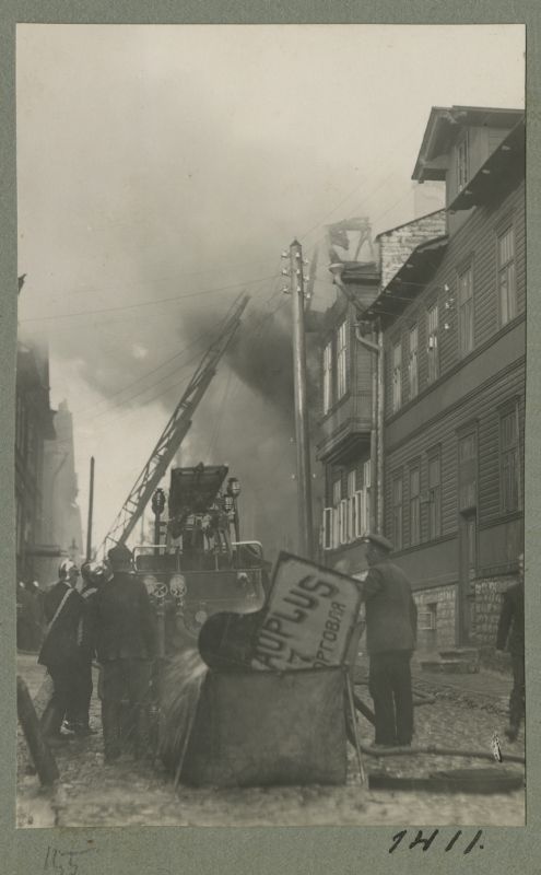 Fire extinguishing in the wooden house district.