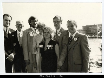 ESTO-80, Global Estonian Days in Stockholm. The Swedish queen and the Estonian flag look away. At the cocktail-reception of the Swedish Estonian presentation in Grand Hotel Royal, Jaan Vilval - Chairman of the Swedish Estonian presentation, representative of the Republic of Estonia Ernst Jaakson, Australian consul Leo Jerkavits, Canada Ambassador Kay Pedersen, Tiiu Kroll-Simmul - Assistant Chairman of the Estonian Society Union of Australia, Mäido Karido i - from the World Central Council of Estonia and Walter Pent - Kanda from the Central Council of Estonia.  duplicate photo