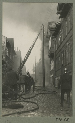 Fire extinguishing in the wooden house district.  similar photo