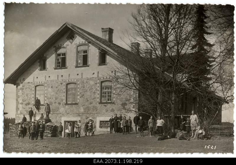 Unidentified Latvian schoolhouse, school family at the forefront