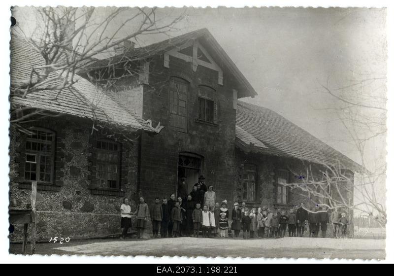Unidentified Latvian school family in front of schoolhouse