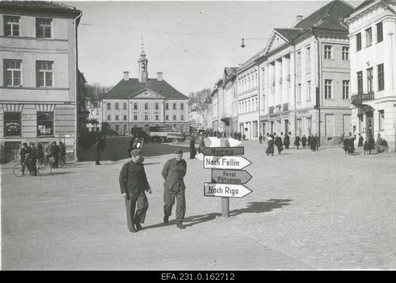 German occupation in Estonia. Teas on Tartu Suur Market. Military cars are parking around the corner.