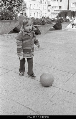A little girl with a ball on Harju Street.  similar photo
