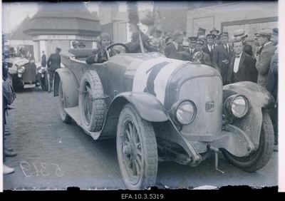 Car racing participants with their car in front of the Exhibition Square.  similar photo