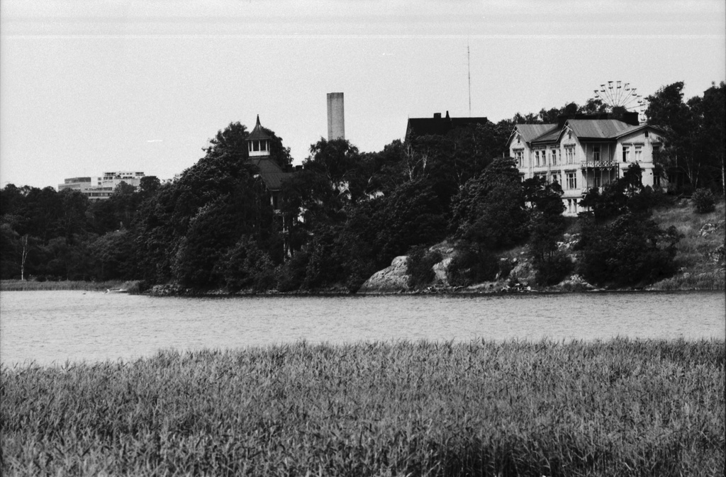 Töölönlahti. Näkymä Töölönlahden rannalta. Vasemmalla Eläintarhan huvila 10 (Villa Kivi), oikealla huvila 11 Linnunlauluntiellä. Taustalla Linnanmäki.