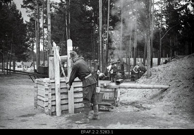 Military camp, soldier digging water.