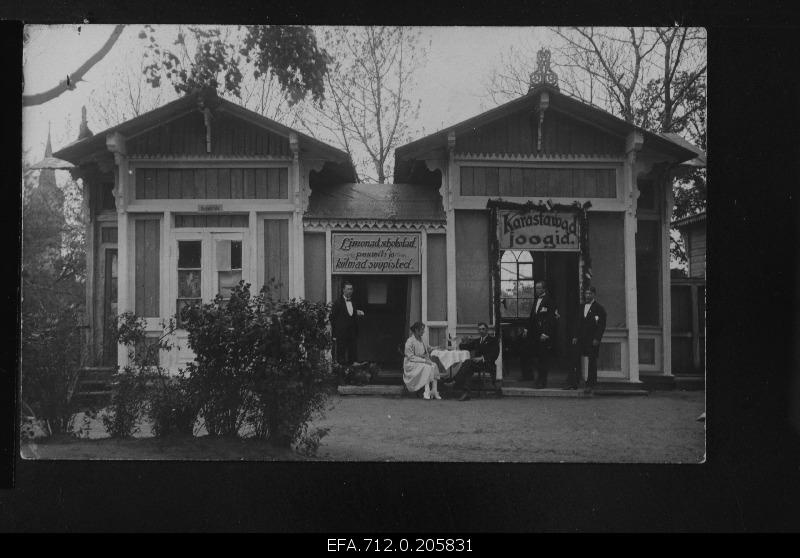 View of the cafe building. Customers, servants in front of the cafe.