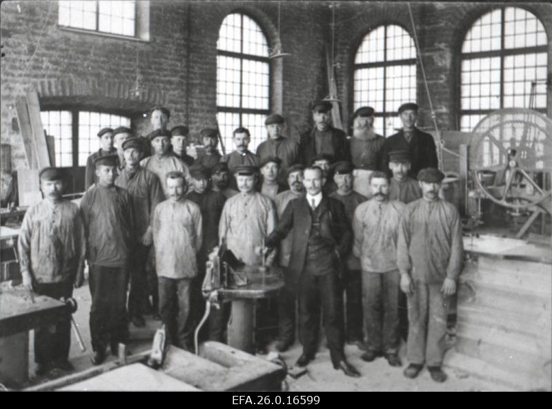 A group of workers at the factory Volta model check.