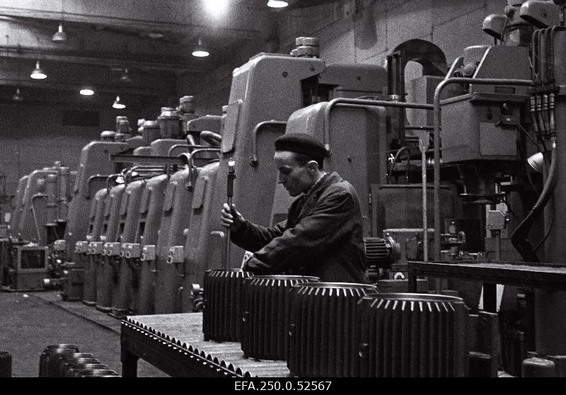 Factory Volta Technical Control Department employee Viktor Markin controls the quality of the engine hulls processed on the automatic line.