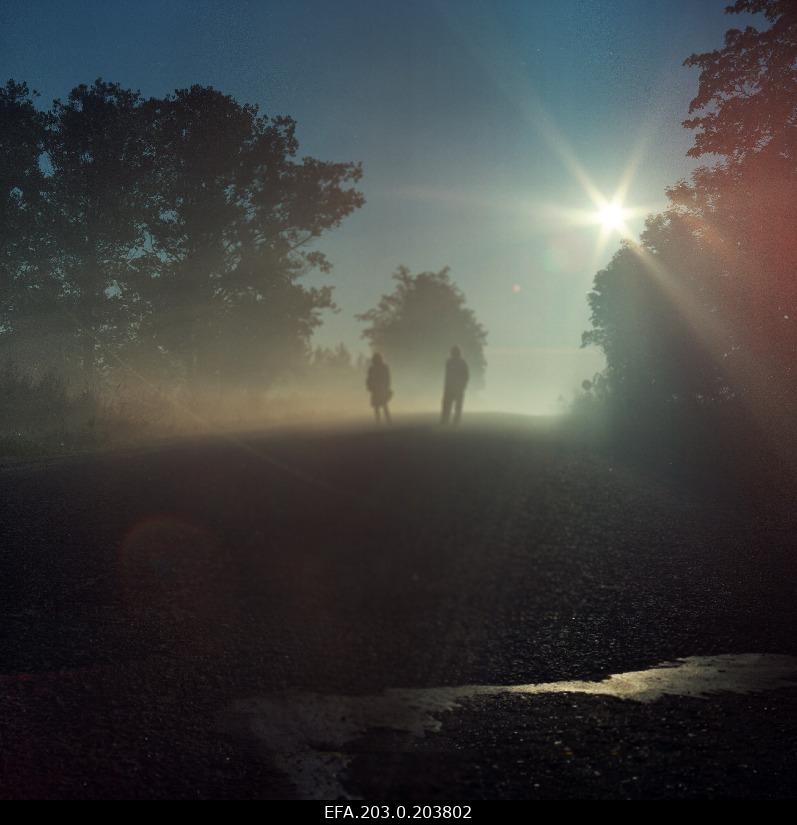 A scene from the game film "Only for mad or merciful sister" - the last sunrise. Rita and Johan siluets fog.