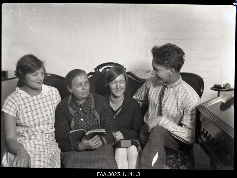 Three women and a man sat on the couch