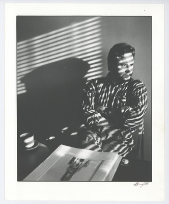 Sitting man with coffee cups and map.  duplicate photo