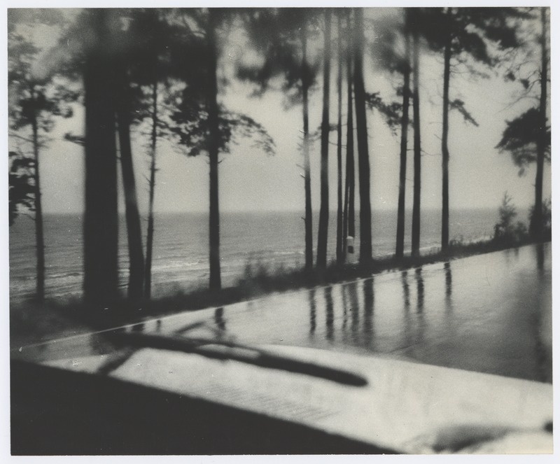 View through the car window: rain sea beach.