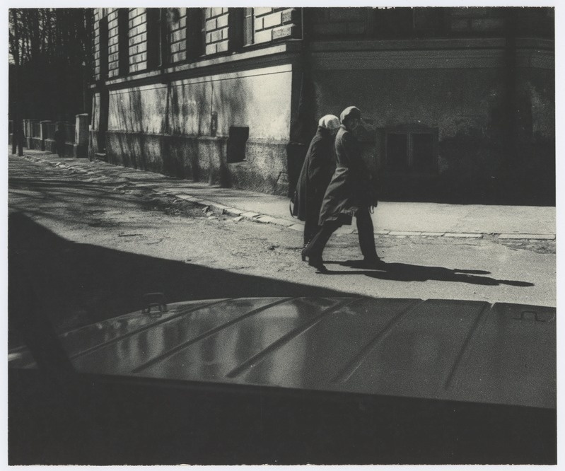 View through the car window: women walk on the street.