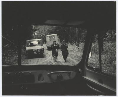 View through the car window: man and woman on the forest road.  duplicate photo