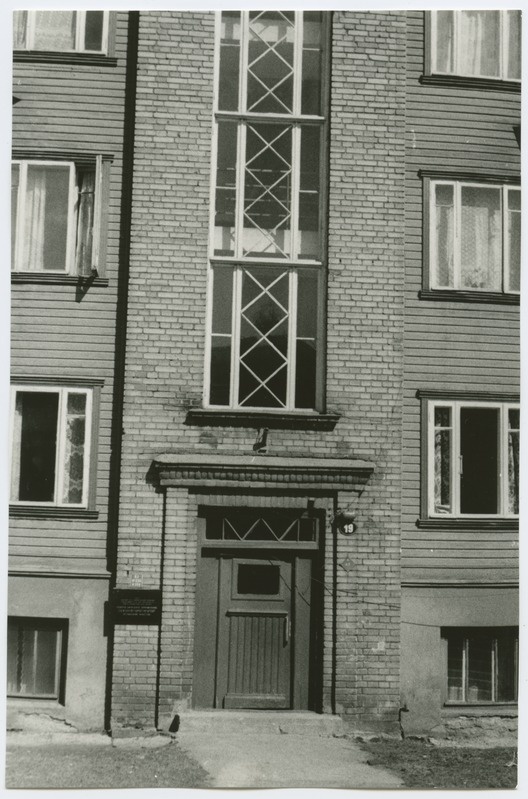 Three-fold wooden house with a stone staircase, Gogol Street 19, the outdoor door of the building and the staircase.