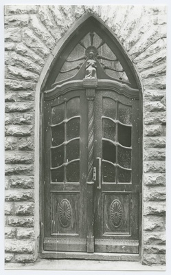 Wooden, glassed house door The walls of the street 26 in the house.  duplicate photo