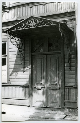 Wooden outdoor door with a cover in the building on the corner of the Soviet and J. Gagarin road.  duplicate photo