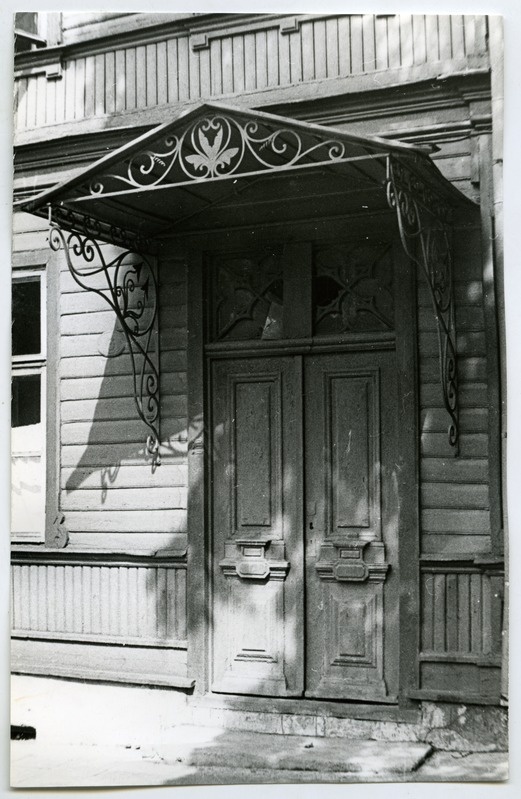 Wooden outdoor door with a cover in the building on the corner of the Soviet and J. Gagarin road.