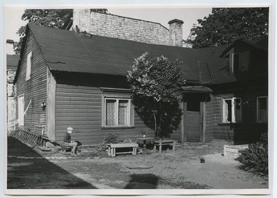 Tallinn, view of the wooden house part of the courtyard. Keldrimäe settlement. In the picture, a small boy is sitting. In the back of the closet.  duplicate photo