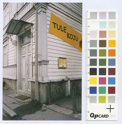 Wooden house on Sakala Street. Outdoor door and squeezing. A slogan on the wall: "Come home."  duplicate photo