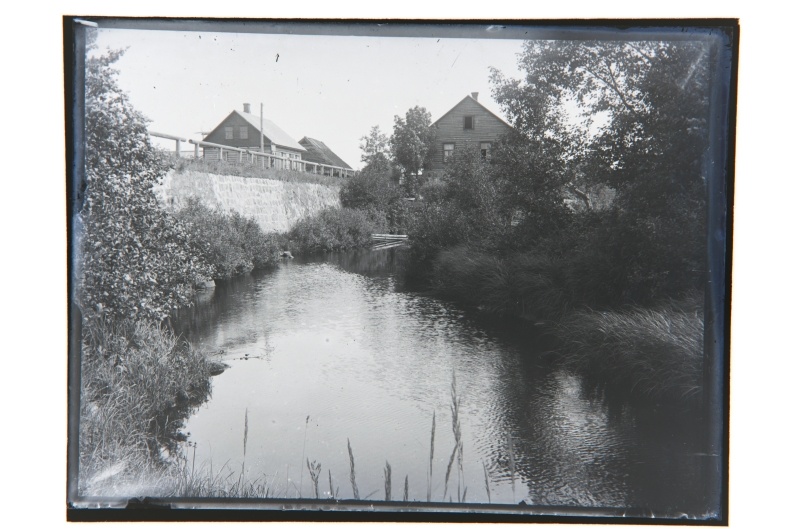View of the river bridge and watermill buildings. Silt on the bridge with a letter: "..."