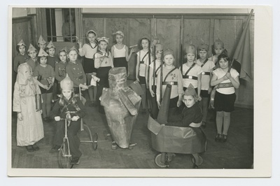 Schoolchildren are playing a war-teemed exhibition game.  duplicate photo